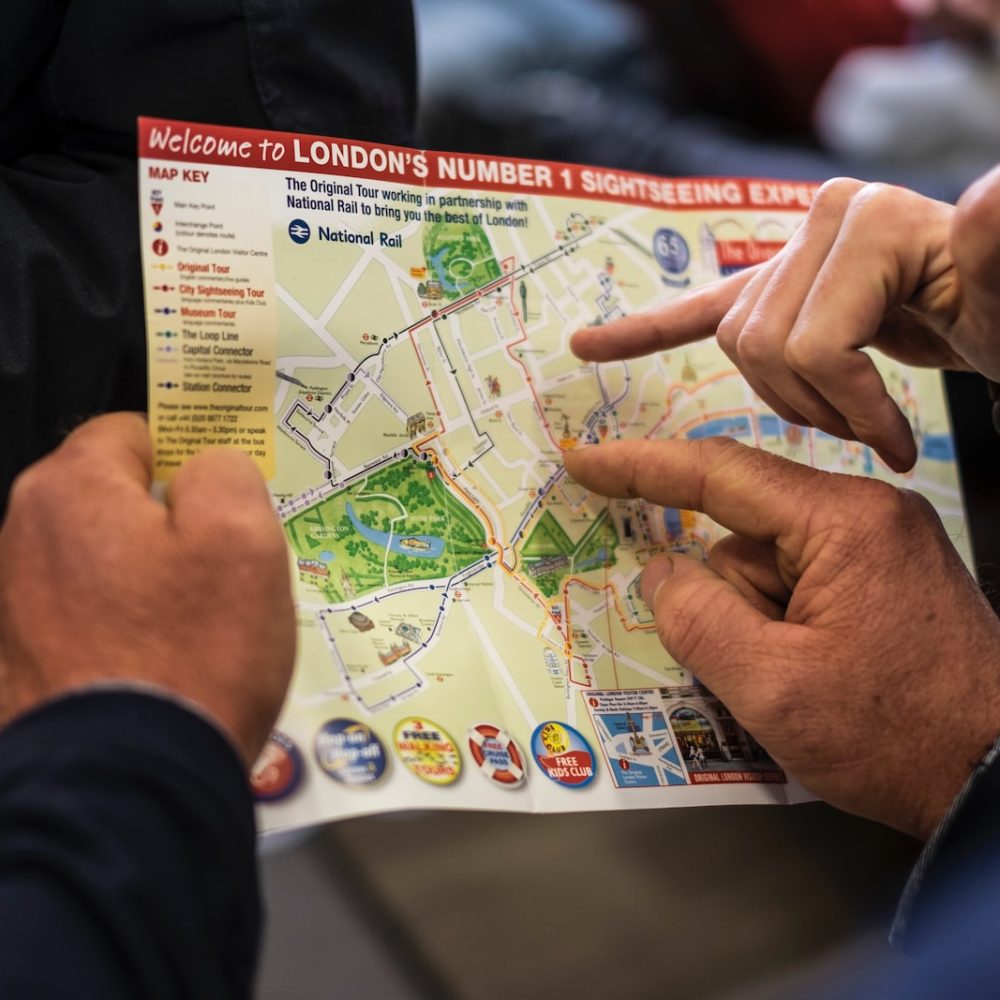 two people pointing at London's number one sightseeing map